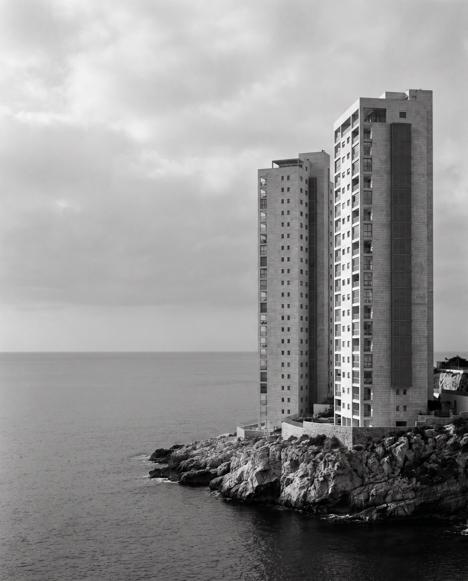 Two pale towers seen against the open sea