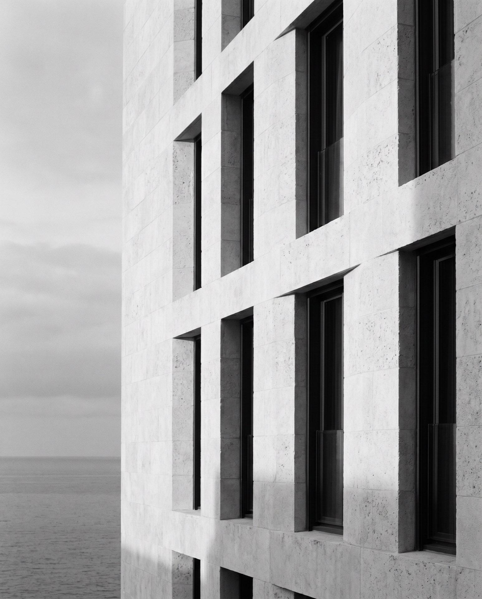 A facade of deep window reveals in pale stone